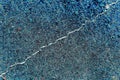 A thin crack in a concrete slab, changed colors, phot in blue tones