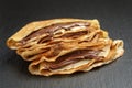 Thin crepes or blinis with chocolate cream on