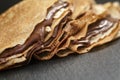 Thin crepes or blinis with chocolate cream on