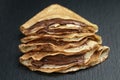 Thin crepes or blinis with chocolate cream on