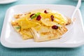 Thin crepes with citrus sauce and dried cranberry