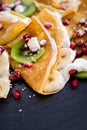 Thin Crepes with melted chocolate, sesame seeds, pomegranate and almonds Royalty Free Stock Photo