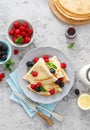 Thin crepes with fresh berries and lemon zest. Pancakes with raspberry and blackberry