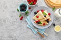 Thin crepes with fresh berries and lemon zest. Pancakes with raspberry and blackberry