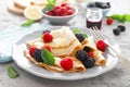 Thin crepes with fresh berries and lemon zest. Pancakes with raspberry and blackberry