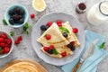 Thin crepes with fresh berries and lemon zest. Pancakes with raspberry and blackberry