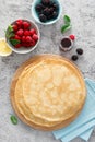 Thin crepes with fresh berries and lemon zest. Pancakes with raspberry and blackberry