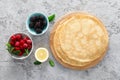 Thin crepes with fresh berries and lemon zest. Pancakes with raspberry and blackberry