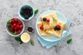 Thin crepes with fresh berries and lemon zest. Pancakes with raspberry and blackberry
