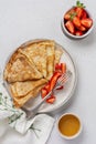 Thin crepes pancakes with cream cheese and fresh strawberry, top view Royalty Free Stock Photo