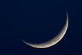 A thin crescent moon on a dark blue background Royalty Free Stock Photo