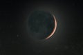 A thin crescent moon with earth shine and background stars Royalty Free Stock Photo
