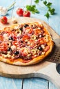 Thin crispy crust pizza with vegetable topping