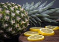 Fresh ripe lemon near a big pineapple. Royalty Free Stock Photo