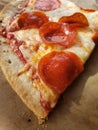 Thin crust pepperoni cheese pizza slice freshly baked