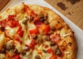 Thin crust Pizza, close up photo of a delicious pizza with mozzarella cheese, onions, meat, tomato Royalty Free Stock Photo