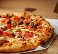 Thin crust Pizza, close up photo of a delicious pizza with mozzarella cheese, onions, meat, tomato Royalty Free Stock Photo