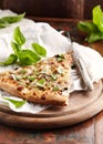 Thin-crust pizza topped with fresh basil leaves. Slice of pizza. Home made food. Italian vegetarian pizz