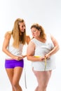 Thin and fat woman measuring waist with tape Royalty Free Stock Photo