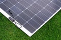 Thin flexible mobile solar panel with cable for connection. Royalty Free Stock Photo