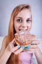 Thin girl eats donut