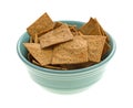 Thin gourmet snack crackers in a green bowl