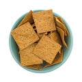 Thin gourmet snack crackers in a green bowl