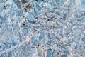 Thin ice in the morning on a rocky beach. Sunrise. Night frosts. Close view. Natural abstract texture. Changeable Royalty Free Stock Photo