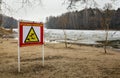 A thin ice warning sign on a city beach