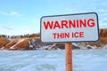 Thin ice warning sign, pond and hills background Royalty Free Stock Photo