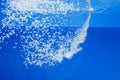a thin jet of water penetrates the water surface