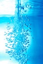 a thin jet of water penetrates the water surface