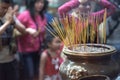 Thin long candles with incense on a special stand