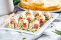 Thin pancake rolls or crepes rolls with smoked salmon, cream cheese, cucumber and dill on a gray concrete background. Maslenitsa Royalty Free Stock Photo