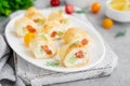 Thin pancake rolls or crepes rolls with smoked salmon, cream cheese, cucumber and dill on a gray concrete background. Royalty Free Stock Photo