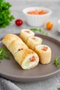 Thin pancake rolls or crepes rolls with smoked salmon, cream cheese, cucumber and dill on a gray concrete background. Royalty Free Stock Photo