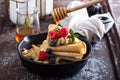 Thin pancakes with apples and fresh berry