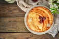 Thin pancakes with cherries. Pancakes in a white plate. Wood background. Sweet food