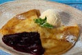 Thin pancakes with creamy berry sauce and ice cream A traditional appetizing dish. Close-up. Pancakes Crept-Suzette Royalty Free Stock Photo