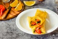 Thin pancakes with red fish on plate, top view.Crepes with filet salmon and cheese, red fish and green avocado on white plate over