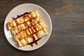 Thin pancakes served with chocolate syrup on plate Royalty Free Stock Photo