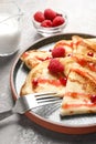 Thin pancakes served with syrup and berries Royalty Free Stock Photo