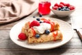 Thin pancakes served with syrup, cream and berries Royalty Free Stock Photo