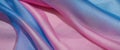 The thin pink and blue fabric sags in folds under its own weight Royalty Free Stock Photo