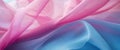 The thin pink and blue fabric sags in folds under its own weight Royalty Free Stock Photo