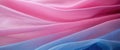 The thin pink and blue fabric sags in folds under its own weight Royalty Free Stock Photo