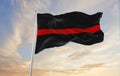Thin Red Line flag waving at cloudy sky background on sunset, panoramic view. Firefighters, Fire Service Personnel flag. copy Royalty Free Stock Photo