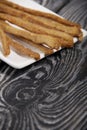 Thin sausages for beer. On a rectangular plate. Background from pine boards. Close-up Royalty Free Stock Photo