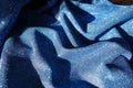 Thin shiny blue lurex fabric in soft folds Royalty Free Stock Photo