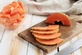 Thin Slice Papaya on Wooden Table, Cubed Papaya on Bowl